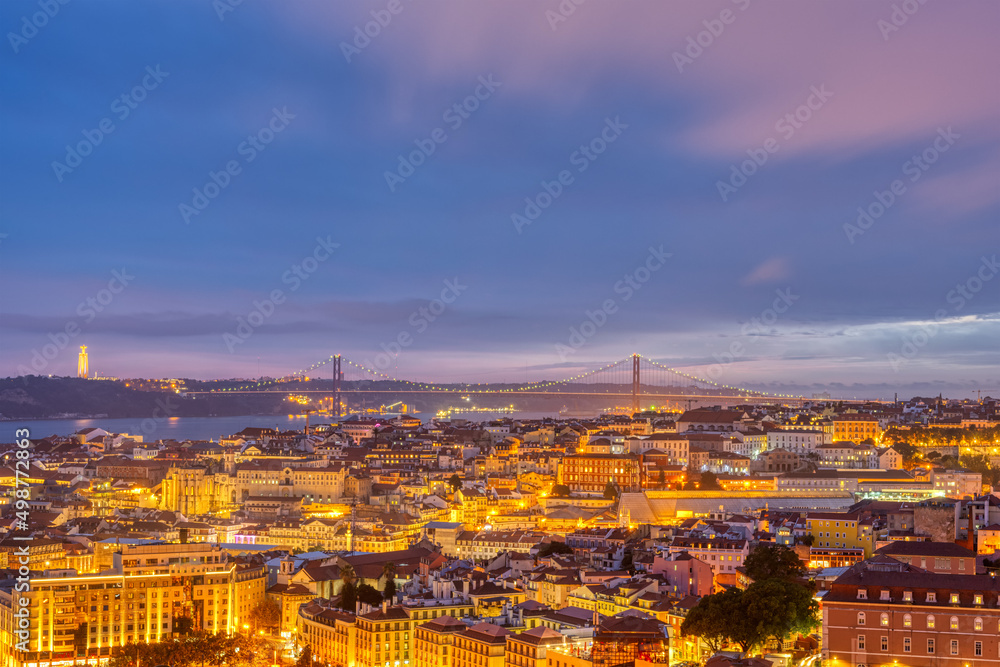 View over downtown Lisbon with the Christ Statue and the 25 de Abril bridge at night
