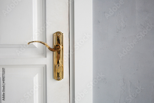Closed door with golden doorknob close up