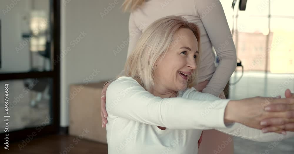 Pregnant woman and her personal trainer doing stretching exercises Pregnant woman and her personal trainer doing stretching exercises