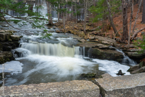 Granite blocks in foreground with long exposure cascade in background