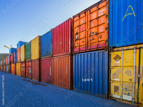 Row of stacked multicovered shipping containers photo