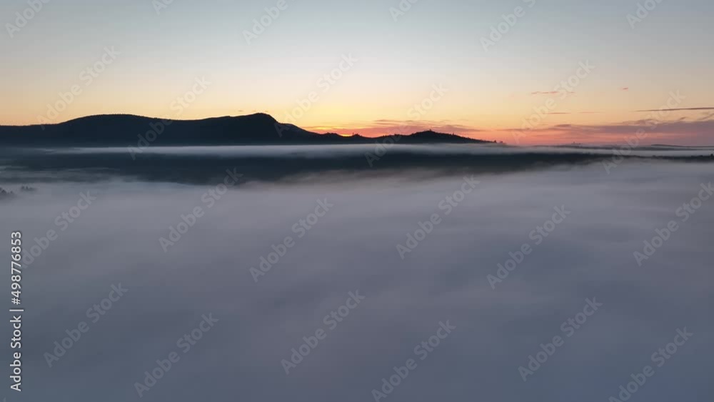 Spectacular sunset over blanket cloud stretching toward mountain Spectacular sunset over blanket cloud stretching toward mountain