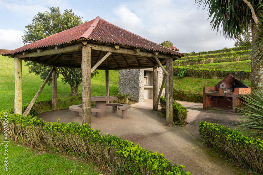 Public park with picnic table in arbor, close to barbeque grill oven Public park with picnic table in arbor, close to barbeque grill oven