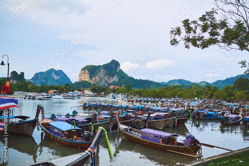 Travel the traditional way. Shot of traditional wooden boats resting on a beach in Thailand. © Ruan J/peopleimages.com