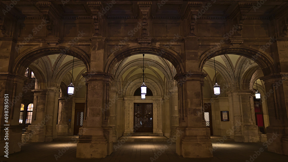 Front view of the side entrance of popular Vienna State Opera building in the old downtown of Vienna, Austria in the dark with lamps and facade. Front view of the side entrance of popular Vienna State Opera building in the old downtown of Vienna, Austria in the dark with lamps and facade.