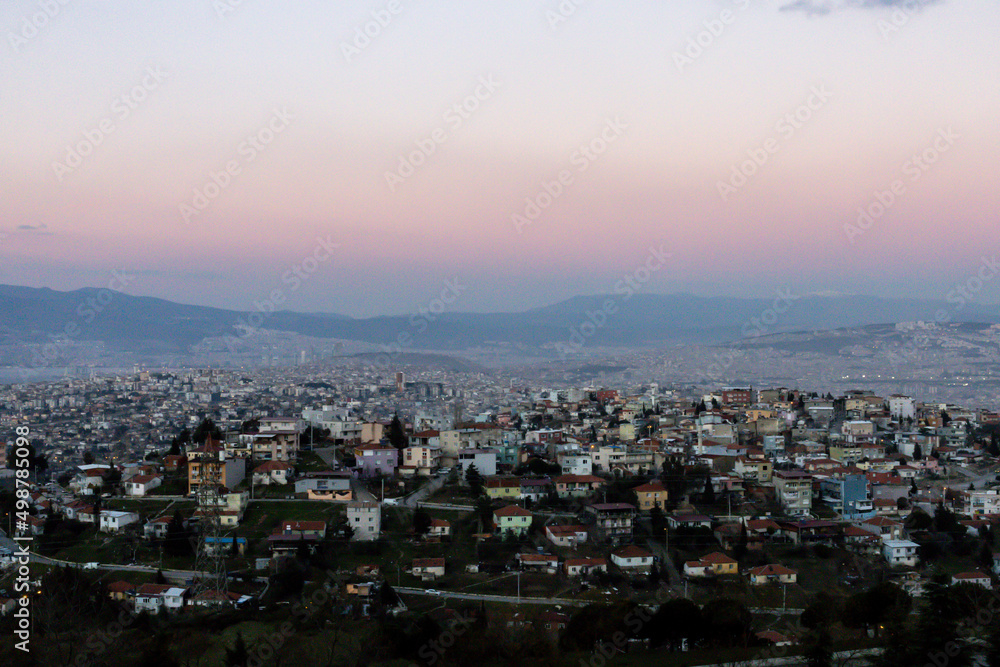 Izmir city view. Pink sky and mountains above city