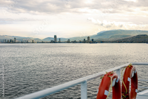 City view of Izmir from ferryboat. Cold grey winter Aegean sea. photo