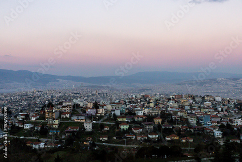 Izmir city view. Pink sky and mountains above city