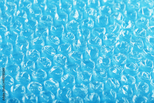 Packing bubble wrap for parcels on a blue background in full screen