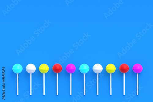Row of colorful lollipops on stick on blue background. Sweet candy. Confectionery goods. Top view. Copy space. 3d render © OlekStock