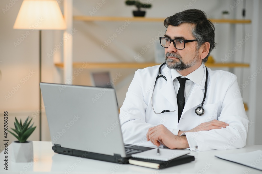 Portrait of attractive mature doctor working in office. Portrait of attractive mature doctor working in office.