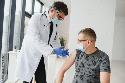 Man with face mask getting vaccinated  coronavirus  covid-19 and vaccination concept