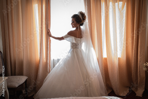 Bride gathering at the hotel. Bouquet of flowers and veil. Loving couple at an international wedding at sunset. Beautiful sophisticated bride of Asian appearance.