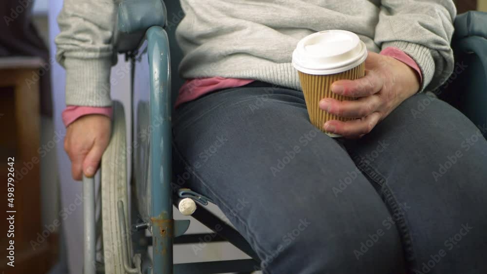 Wheelchair user with take out coffee Wheelchair user with take out coffee
