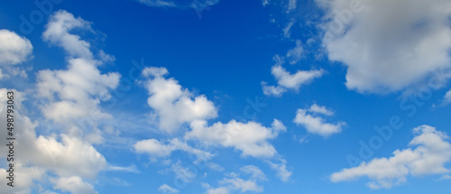 Blue sky with beautiful white clouds. Wide photo.