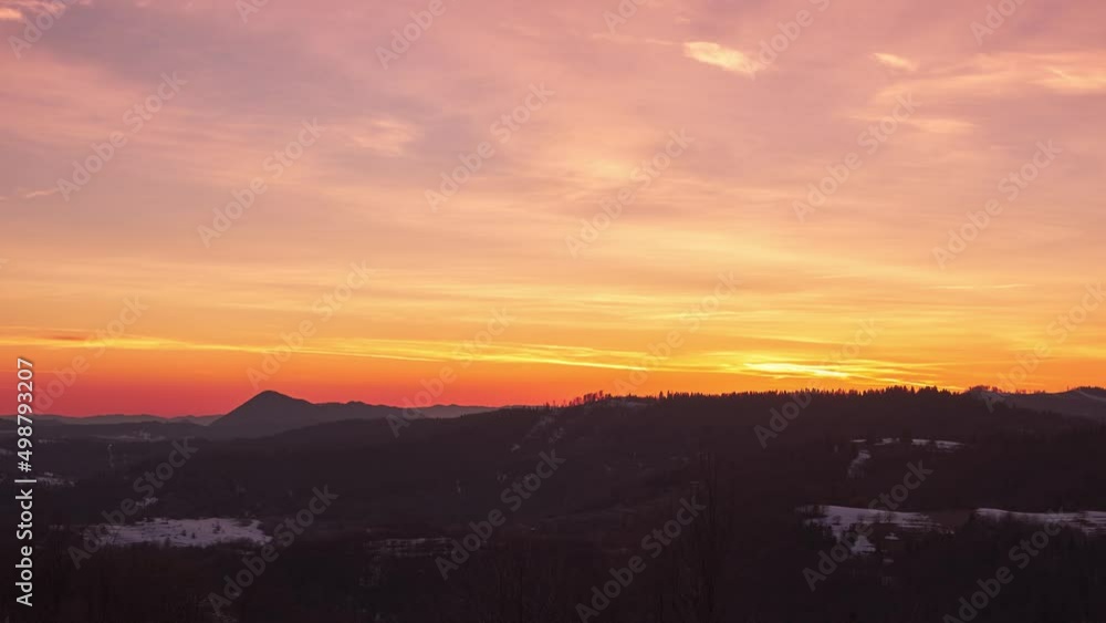 Pastel sky with slow moving clouds at dusk over forest landscape in spring. Pastel sky with slow moving clouds at dusk over forest landscape in spring.