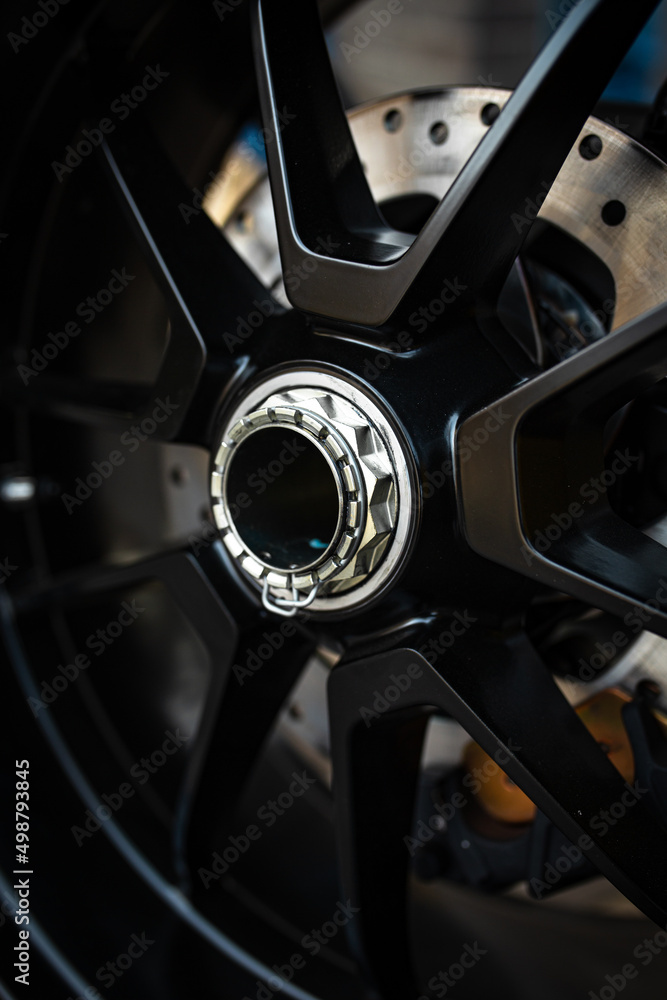 black new motorcycle disc with brakes close-up black new motorcycle disc with brakes close-up