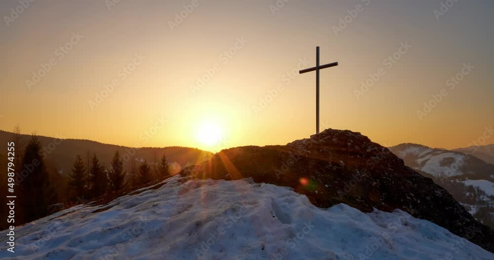 Christian cross on a snowy rock at sunrise, clear sky, golden hour, Timelapse 4K Christian cross on a snowy rock at sunrise, clear sky, golden hour, Timelapse 4K