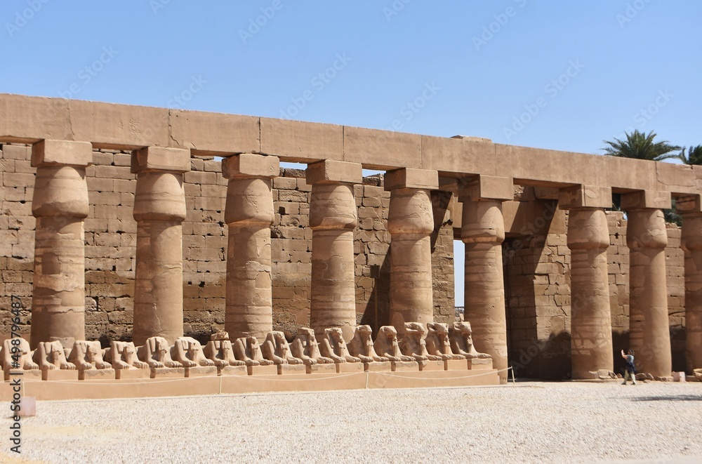 Part of the Karnak Temple Complex in Luxor, Egypt. Pillars and row of ram-headed sphinxes. 