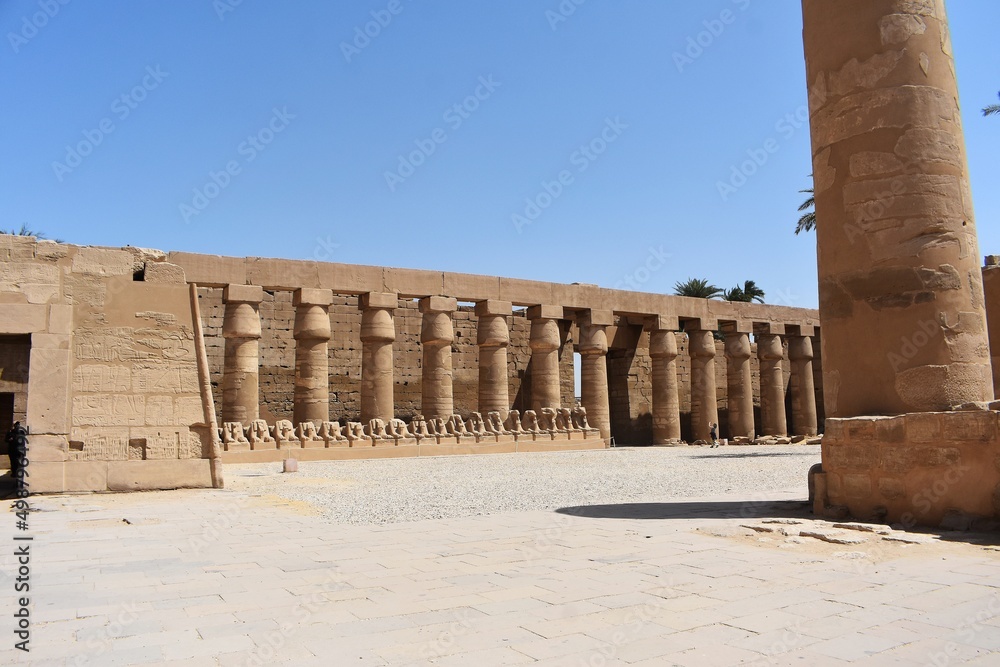 Part of the Karnak Temple Complex in Luxor, Egypt. Pillars and row of ram-headed sphinxes. 