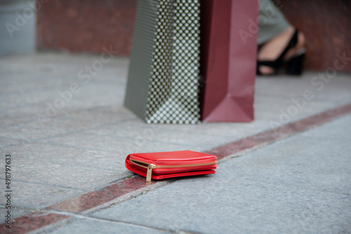 woman and a wallet on the ground in street