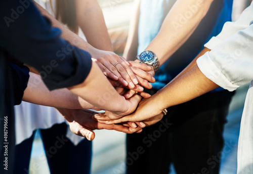 Team support. Cropped shot of an unrecognizable group of people putting their hands together in unity outside.