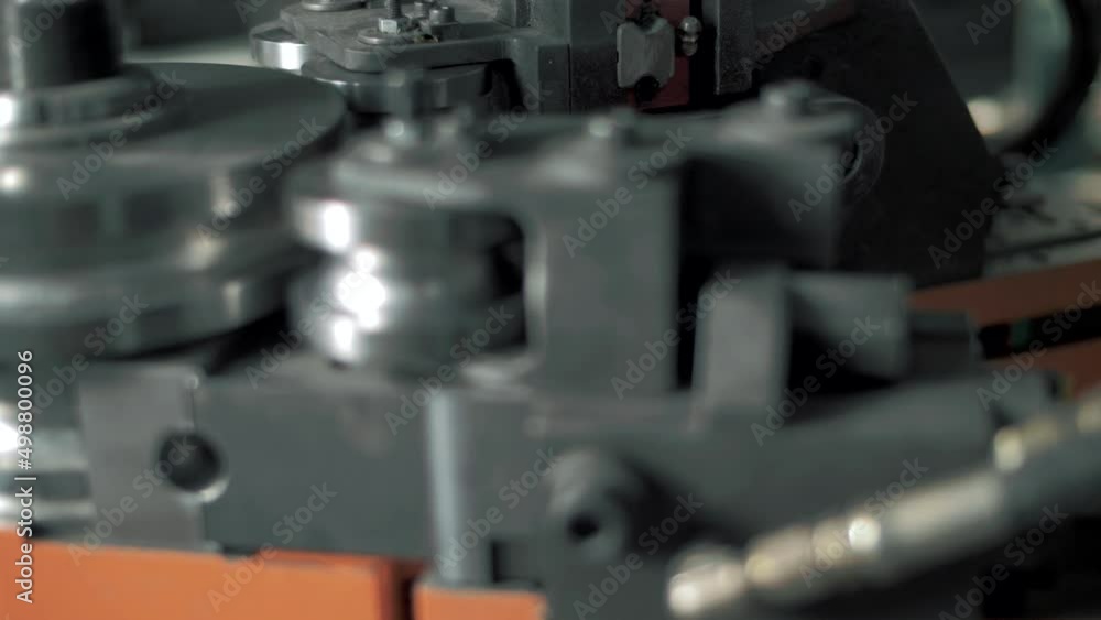 Operating the elements of a CNC machine in a factory Operating the elements of a CNC machine in a factory