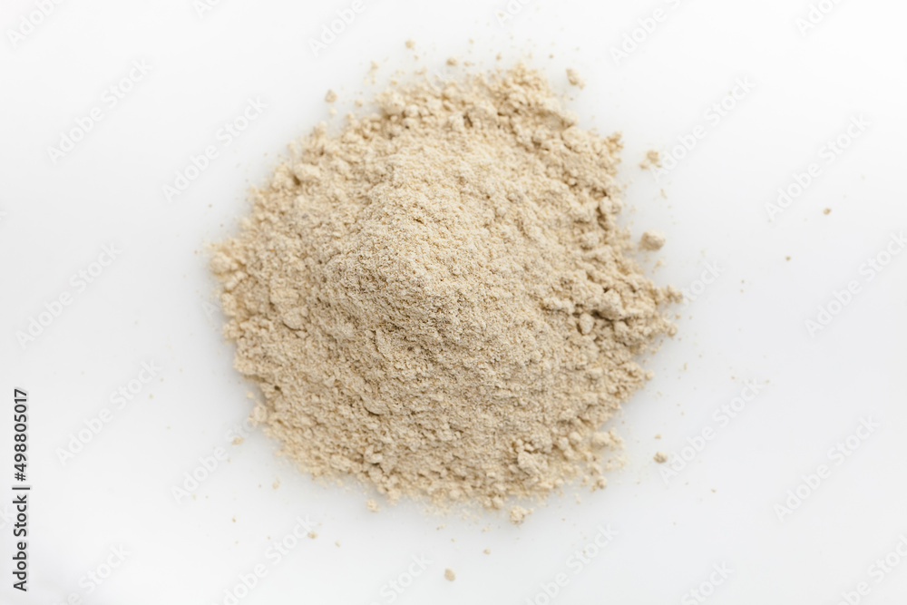 Heap of ginger powder. Isolated on white. Top view. Heap of ginger powder. Isolated on white. Top view.