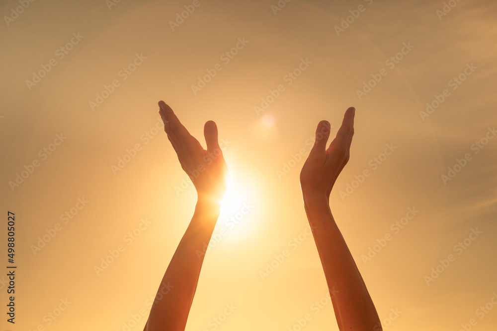 Praise and worshiping hands up to the sky 