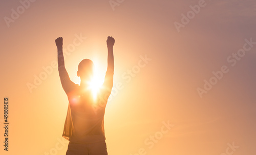 People winning, victory concept. Happy young woman with fist in to the sky. 