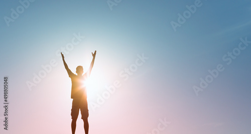 Happy man with arms in the air feeling free