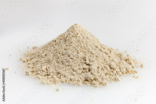 Heap of ginger powder. Isolated on white. Top view.