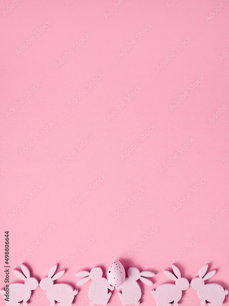 21.	Easter composition made with Easter bunnies and egg on bright pink background. Minimal creative holiday concept.
