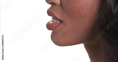Close up side view of a black woman mouth speaking.