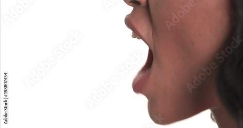 Close up side view of a black woman mouth shouting.
