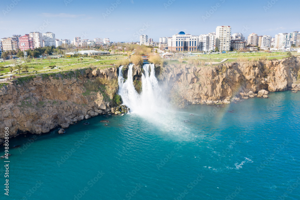 Obraz premium Waterfall, cascade Duden (Düden), falling into the Mediterranean sea with rainbow scene. Waterfall falling into sea. Waterfall stream. Aerial view drone shooting. ANTALYA