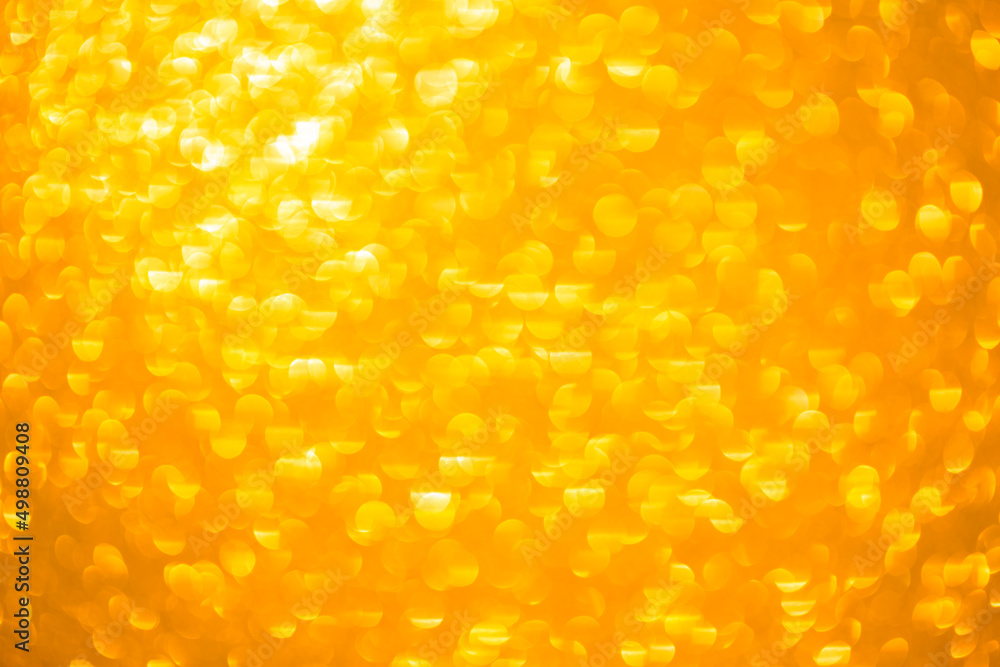 Background texture of shiny golden bokeh. Beautiful festive christmas background for greeting design. Nacreous sparkling yellow texture. Background texture of shiny golden bokeh. Beautiful festive christmas background for greeting design. Nacreous sparkling yellow texture.