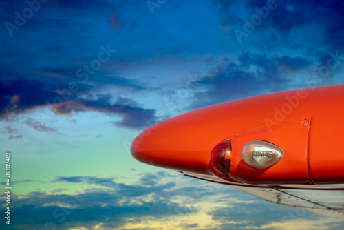 Close-up of a wingtip with landing lights against a picturesque sky as a concept for general aviation and pilot training. photo