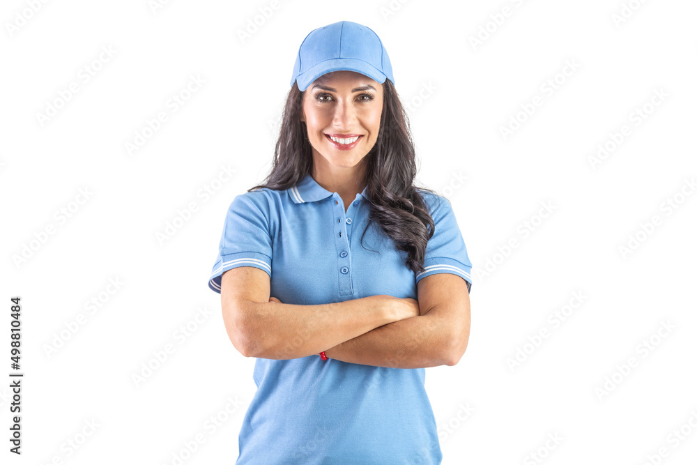 Dark-haired widely smiling woman standing in blue cap and t-shirt with hands crossed over chest. Isolated background