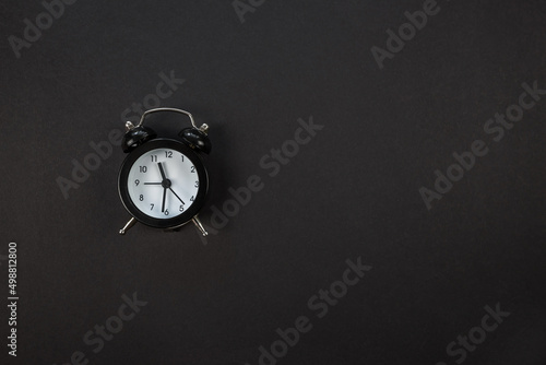 Wallpaper Mural Top view of a black alarm clock on a black background Torontodigital.ca