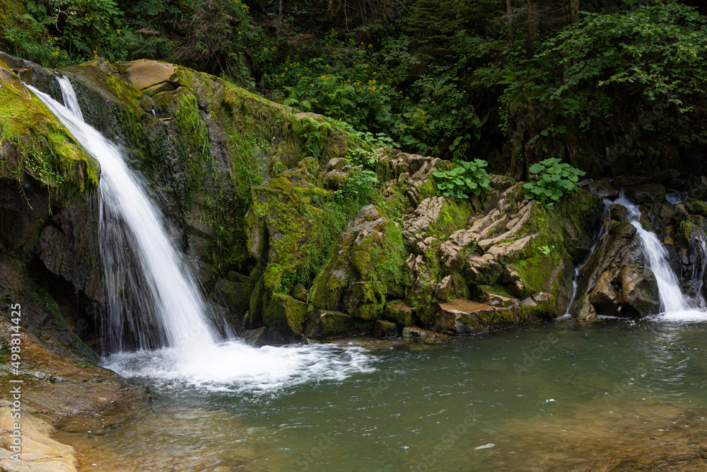 Fototapeta premium Two small mountain waterfalls in forest