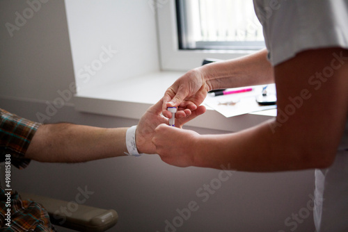 A nurse monitors the blood sugar of diabetic patients. photo