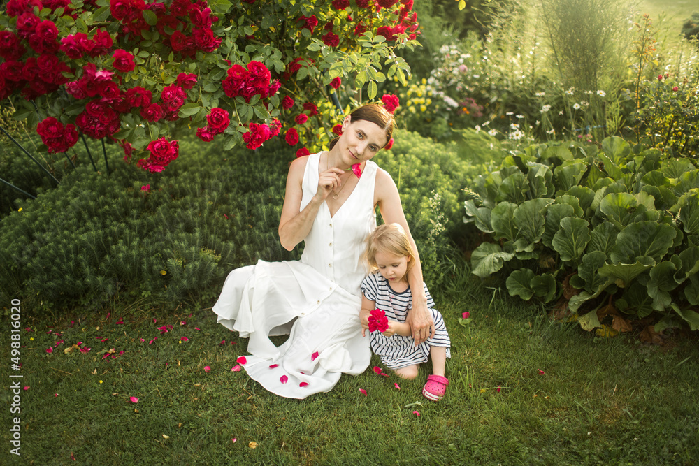 mother hugs her daughter, relax, collect a bouquet of roses