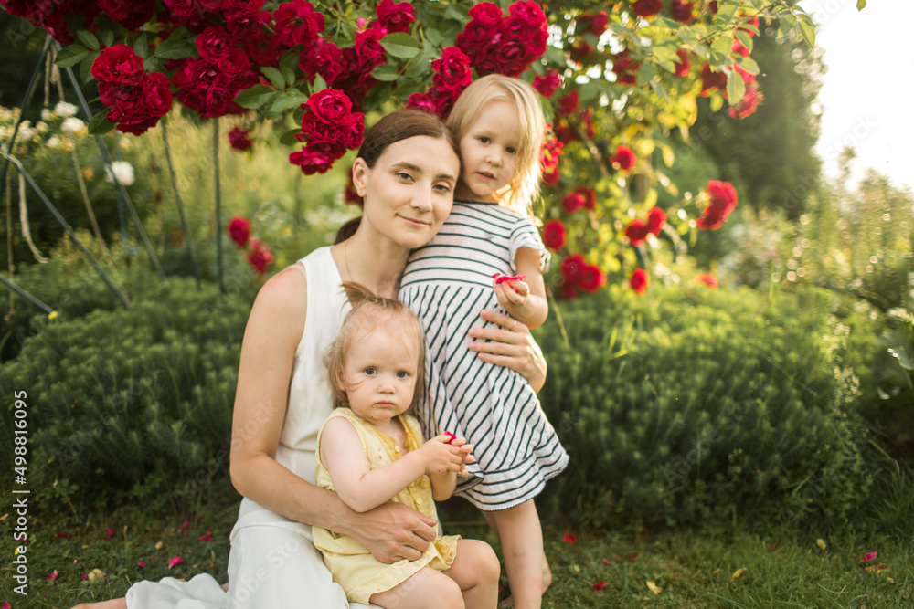 mother hugs her daughter, relax, collect a bouquet of roses
