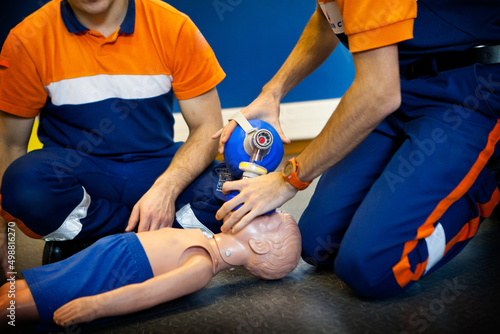 First aid training: use of a manual resuscitator bag on a child. photo