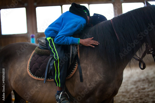Bild auf Leinwand Equitherapy session for an autistic in an equestrian center.