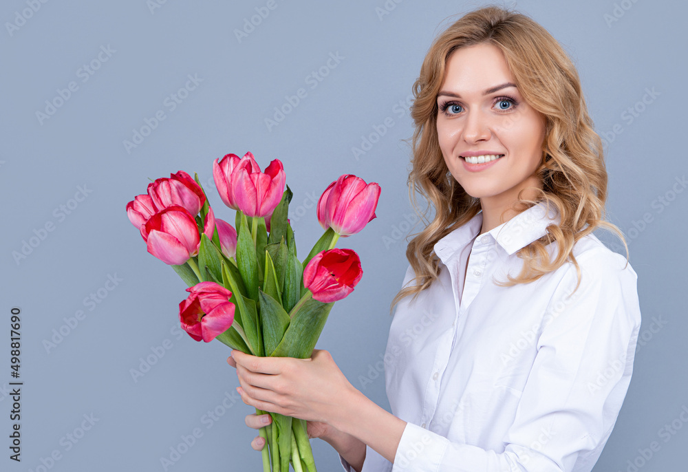 face of happy young woman with spring tulip flowers on grey background face of happy young woman with spring tulip flowers on grey background