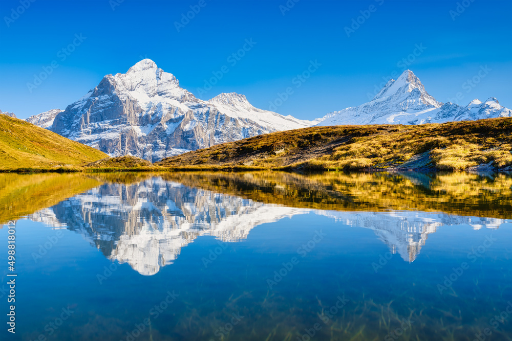 Obraz premium High mountains and reflection on the surface of the lake. Mountain valley with lake. Landscape in the highlands in the summertime. Photo in high resolution.