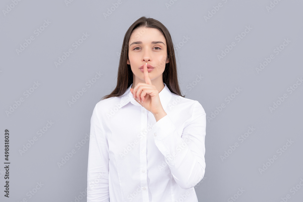 hush gesture of businesswoman in white shirt on grey background, entrepreneur hush gesture of businesswoman in white shirt on grey background, entrepreneur