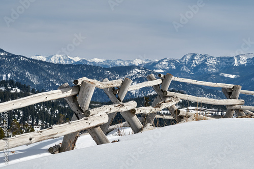 Jackleg fence of lodgepole pine near Big Sky, Montana with the Spanish Peaks range in the background.